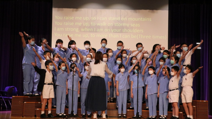 The school choir, together with the whole student body, pray by singing hymns